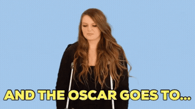 A Woman Is Standing In Front Of A Blue Background And The Oscar Goes To ... GIF