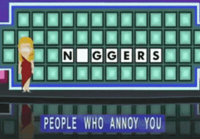 A Woman Is Standing In Front Of A Board That Says Niggers GIF