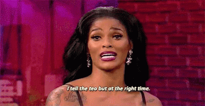 A Woman Is Standing In Front Of A Brick Wall And Saying `` I Tell The Tea But At The Right Time '' . GIF