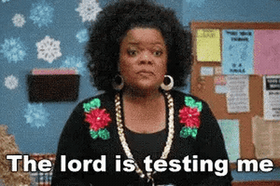 A Woman Is Standing In Front Of A Bulletin Board With The Words `` The Lord Is Testing Me '' . GIF