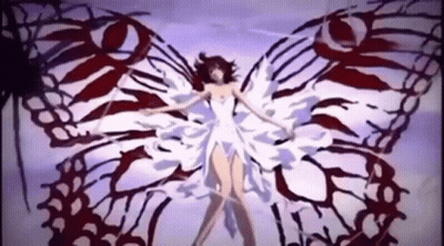 A Woman Is Standing In Front Of A Butterfly With Red And White Wings . GIF