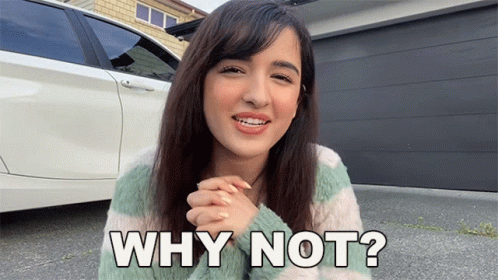 A Woman Is Standing In Front Of A Car And Asking Why Not ? GIF