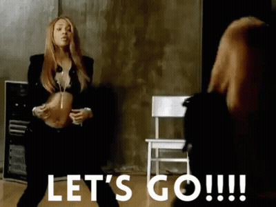 A Woman Is Standing In Front Of A Chair With The Words Let 'S Go !!! Below Her GIF