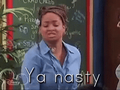 A Woman Is Standing In Front Of A Chalkboard With The Words Ya Nasty Written On It GIF