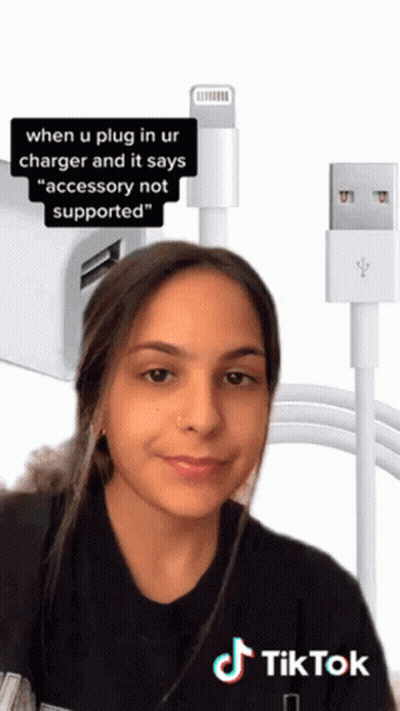 A Woman Is Standing In Front Of A Charger That Says Accessory Not Supported On It GIF
