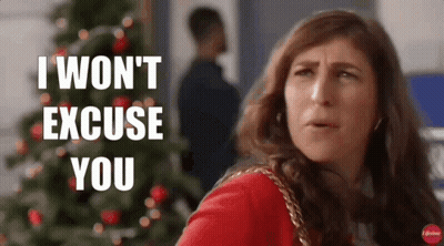 A Woman Is Standing In Front Of A Christmas Tree And Saying I Won 'T Excuse You GIF