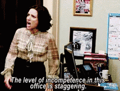A Woman Is Standing In Front Of A Computer With The Words " The Level Of Incompetence In This Office Is Staggering " Abo GIF