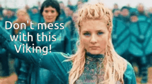 A Woman Is Standing In Front Of A Crowd With The Words " Do N't Mess With This Viking " On The Bottom GIF