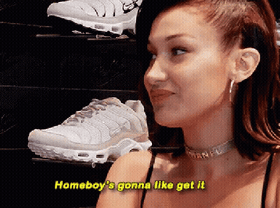 A Woman Is Standing In Front Of A Display Of Shoes And Says " Homeboy 'S Gonna Like Get It " . GIF