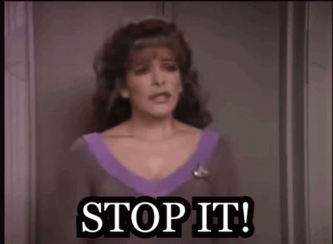 A Woman Is Standing In Front Of A Door And Saying Stop It GIF