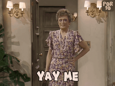 A Woman Is Standing In Front Of A Door And Says Yay Me GIF