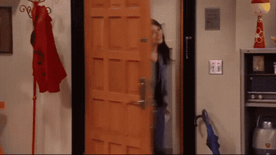 A Woman Is Standing In Front Of A Door That Says ' Amanda ' On It .. GIF