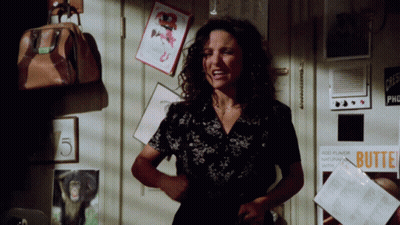 A Woman Is Standing In Front Of A Door With A Sign That Says Butte GIF