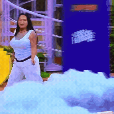 A Woman Is Standing In Front Of A Fantastics Advertisement GIF