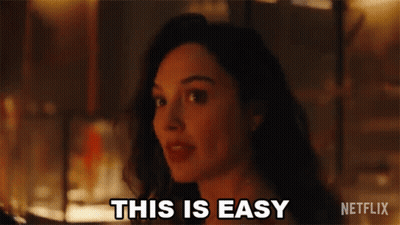 A Woman Is Standing In Front Of A Fire And Saying `` This Is Easy '' . GIF