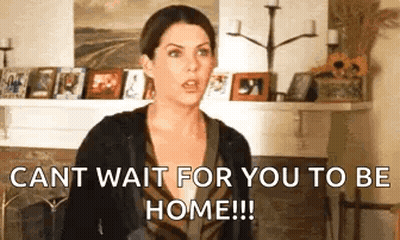 A Woman Is Standing In Front Of A Fireplace In A Living Room And Says `` Cant Wait For You To Be Home ! '' GIF