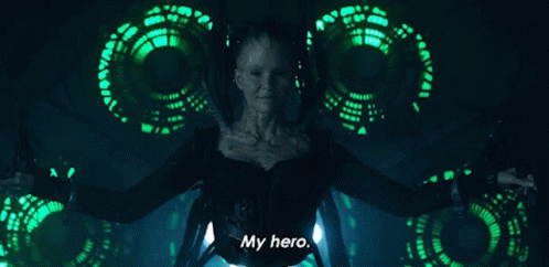 A Woman Is Standing In Front Of A Green Background And Says My Hero GIF