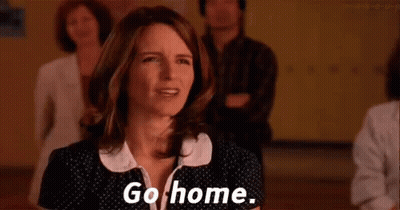 A Woman Is Standing In Front Of A Group Of People And Saying `` Go Home . '' GIF