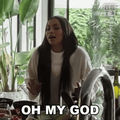 A Woman Is Standing In Front Of A Kitchen Sink And Says Oh My God . GIF