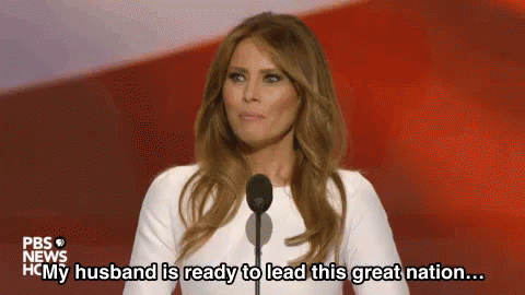 A Woman Is Standing In Front Of A Microphone And Saying `` My Husband Is Ready To Lead This Great Nation ... '' . GIF
