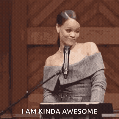 A Woman Is Standing In Front Of A Microphone With The Words `` I Am Kinda Awesome '' Written Below Her . GIF