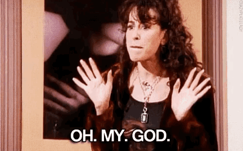 A Woman Is Standing In Front Of A Mirror With Her Hands Up And Saying `` Oh , My God '' . GIF