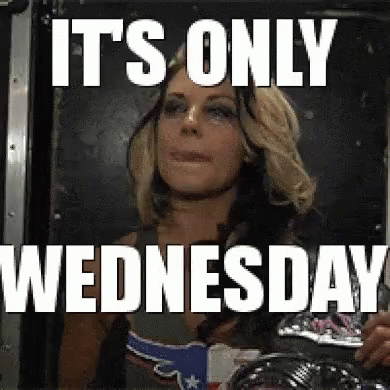 A Woman Is Standing In Front Of A Mirror With The Words `` It 'S Only Wednesday '' Written Above Her . GIF