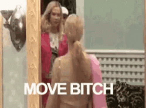 A Woman Is Standing In Front Of A Mirror With The Words `` Move Bitch '' Written Above Her . GIF