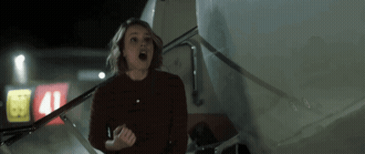 A Woman Is Standing In Front Of A Plane With The Number 41 On The Side GIF
