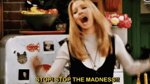A Woman Is Standing In Front Of A Refrigerator And Screaming . GIF