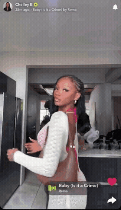 A Woman Is Standing In Front Of A Refrigerator With The Words Baby Is It A Crime GIF