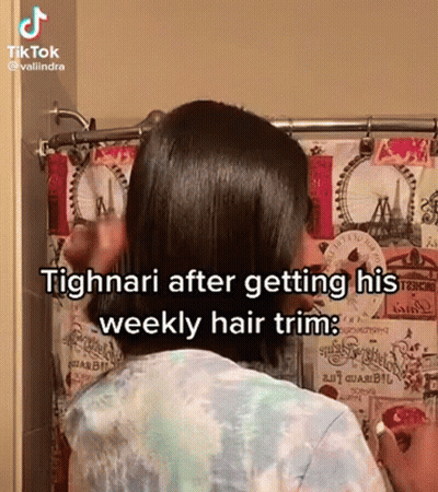 A Woman Is Standing In Front Of A Shower Curtain While Getting Her Hair Trimmed . GIF