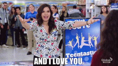 A Woman Is Standing In Front Of A Sign That Says `` And I Love You '' In A Store . GIF