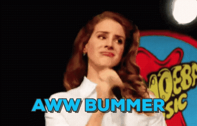 A Woman Is Standing In Front Of A Sign That Says Aww Bummer Sic GIF