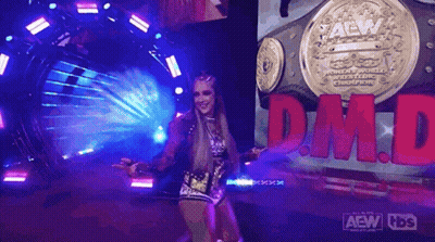 A Woman Is Standing In Front Of A Sign That Says Dm.d. GIF