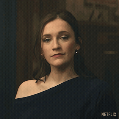 A Woman Is Standing In Front Of A Sign That Says " Done " GIF