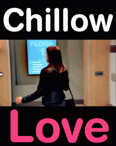 A Woman Is Standing In Front Of A Sign That Says Floor 1 On It GIF