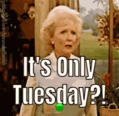 A Woman Is Standing In Front Of A Sign That Says `` It 'S Only Tuesday '' . GIF