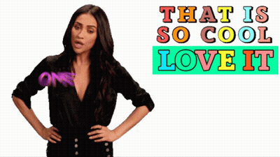 A Woman Is Standing In Front Of A Sign That Says That Is So Cool Love It Omg GIF