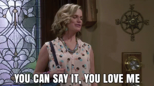 A Woman Is Standing In Front Of A Stained Glass Window And Says You Can Say It You Love Me GIF
