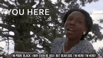 A Woman Is Standing In Front Of A Tree And Says You Here . GIF