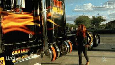 A Woman Is Standing In Front Of A Truck That Says The Man GIF