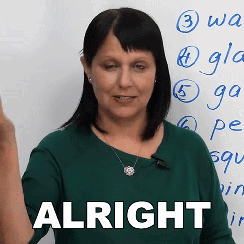 A Woman Is Standing In Front Of A White Board With The Word Alright On It GIF