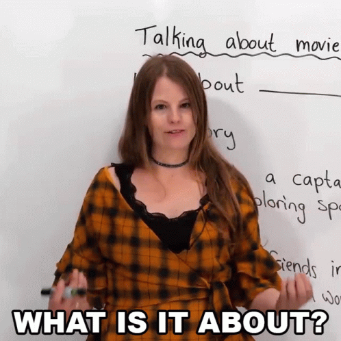 A Woman Is Standing In Front Of A White Board With The Words What Is It About Written On It GIF