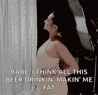 A Woman Is Standing In Front Of A White Curtain And Says " Babe I Think All This Beer Drinkin Makin ' Me Fat " GIF