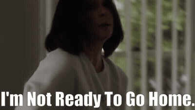A Woman Is Standing In Front Of A Window And Says I 'M Not Ready To Go Home GIF