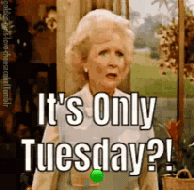 A Woman Is Standing In Front Of A Window And Says It 'S Only Tuesday . GIF