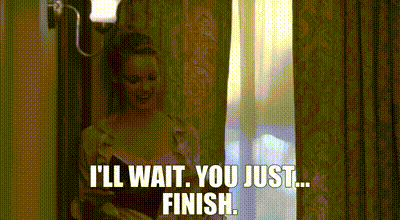 A Woman Is Standing In Front Of A Window And Talking To Someone . GIF