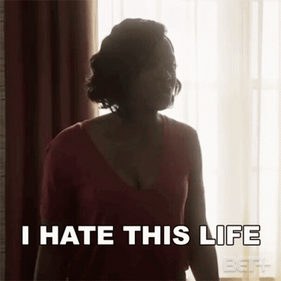 A Woman Is Standing In Front Of A Window With The Words `` I Hate This Life '' Written On Her Face . GIF