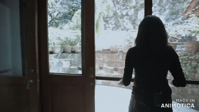 A Woman Is Standing In Front Of A Window With The Words Made In Animotica On The Bottom GIF